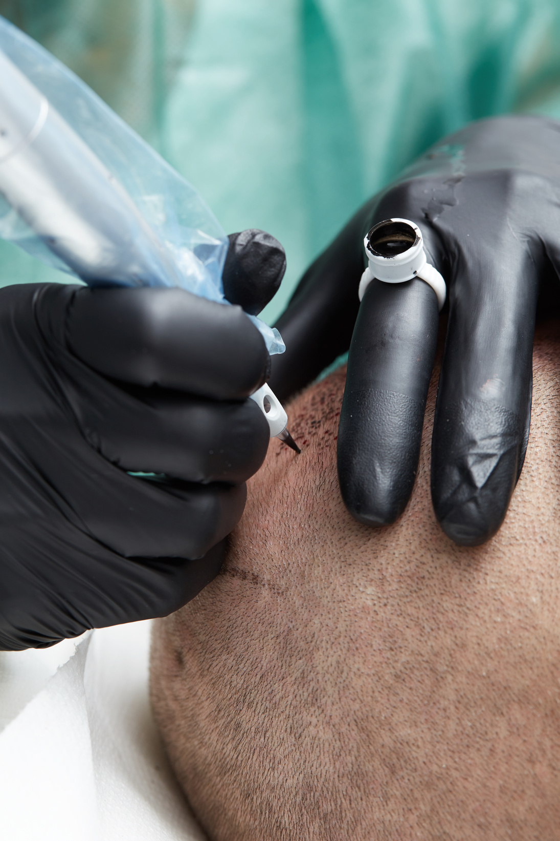 Cosmetologist making permanent makeup on man head - tricopigmentation